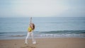 Girl performing modern dance on evening ocean shore. Woman dancer moving body Royalty Free Stock Photo