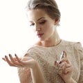 Girl with perfume, young beautiful woman holding bottle of perfume and smelling aroma Royalty Free Stock Photo