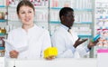 girl pharmacist dispensing prescription medicines