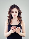 Girl with phone. Young woman with smartphone texting Royalty Free Stock Photo