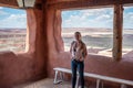 girl with photo camera on the porch of the old indigenous house in Petrified Forest National Park Royalty Free Stock Photo