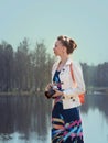 Girl photographer with backpack walking in nature