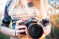 Girl photographer holds Nikon D610 camera and Nikkor 50mm f/1.4G lens