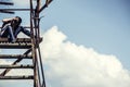 Girl the photographer sits an old ladder Royalty Free Stock Photo