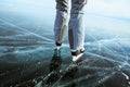 Girl photographer walking on cracked ice of a frozen lake Baikal Royalty Free Stock Photo