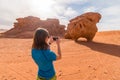 Girl photographing chicken rock in Wadi Rum desert, Middle East, Jordan