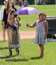 Girl photographing friend with umbrella