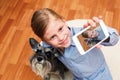 Girl photographing herself and her dog Royalty Free Stock Photo