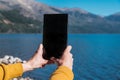 Girl photographing the lake on the table Royalty Free Stock Photo