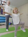 girl on physiotherapy in a children therapy center. Kid doing exercises training with physiotherapists