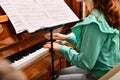 A girl on the piano learns new pieces from notes and plays at a music school Royalty Free Stock Photo