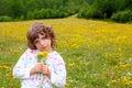 Girl picking flowers in yellow spring meadow Royalty Free Stock Photo