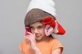 Girl picking her nose with a homemade funny hat