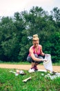 Girl picking up trash doing plogging Royalty Free Stock Photo