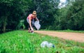 Girl picking up trash doing plogging Royalty Free Stock Photo
