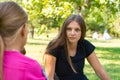 The girl on a picnic listens attentively to the interlocutor