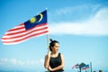 Girl on pier with Malaysian flag Royalty Free Stock Photo