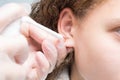 Girl pierced ears in the cabin, close-up