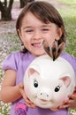 Girl with Piggy Bank Royalty Free Stock Photo