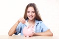 Girl with piggybank and dollar banknote Royalty Free Stock Photo