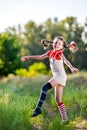 Girl with pigtails imagines the summer on the nature