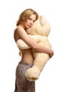 Girl in pijamas pants hugging giant plush bear