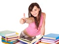 Girl with pile book showing thumb up.