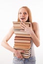 Shoked girl with pile color stacked book on white