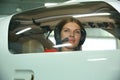 Girl pilot looks out the sports airplane window