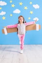 Girl pilot playing with toy jet pack at home. Success and leader concept Royalty Free Stock Photo