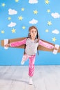 Girl pilot playing with toy jet pack at home. Success and leader concept Royalty Free Stock Photo