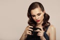 Girl in pin-up style holds retro camera in her hand Royalty Free Stock Photo