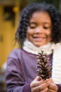 Girl with a pine cone Royalty Free Stock Photo