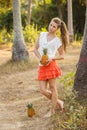 Girl with pineapple near the tree