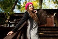 A girl in a pink beret is standing on a wooden staircase Royalty Free Stock Photo