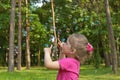 The girl in a pink blouse releases bubble