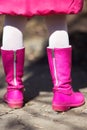 Girl in pink boots on a spring day. Royalty Free Stock Photo