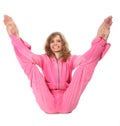 Girl in pink clothes does gymnastic exercise