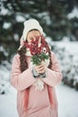 Girl in pink coat in snow Park. Girl plays in winter Park. Adorable child walking in snow winter forest Royalty Free Stock Photo