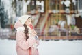 Girl in pink coat in snow Park. Girl plays in winter Park. Adorable child walking in snow winter forest