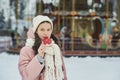 Girl in pink coat in snow Park. Girl plays in winter Park. Adorable child walking in snow winter forest Royalty Free Stock Photo