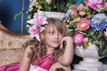 Girl in a pink dress among the flowers