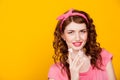 Girl in pink dress pinup-style eats cake with cream Royalty Free Stock Photo