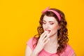 Girl in pink dress pinup-style eats cake with cream Royalty Free Stock Photo