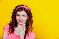 Girl in pink dress pinup-style eats cake with cream Royalty Free Stock Photo