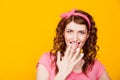 Girl in pink dress pinup-style eats cream licks fingers Royalty Free Stock Photo