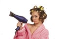 Girl in pink dressing gown with blue hairdryer Royalty Free Stock Photo