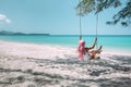 Girl with pink hair hanging on swing at beach Royalty Free Stock Photo