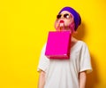 Girl with pink hair holding a colored shopping bag Royalty Free Stock Photo