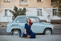 Girl with pink hair posing near old fashioned car. Fun and spare time. Street style, new emotions and city walk concept